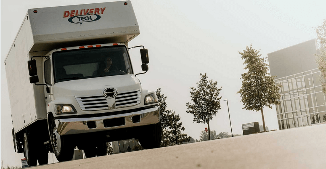 A Delivery Tech delivery truck driving down the road in Edmonton
